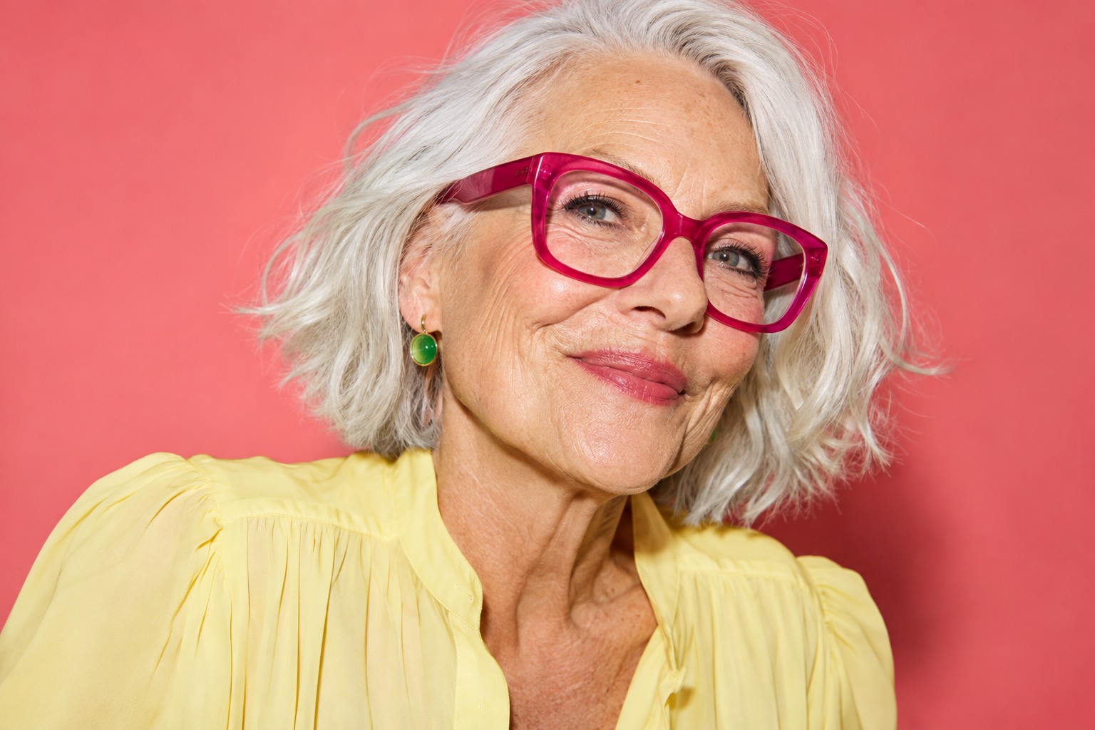 A joyful woman in statement pink glasses